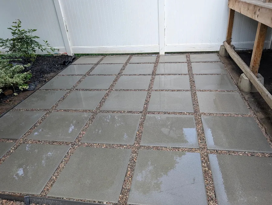 Finished patio of large pavers with pea gravel set between them